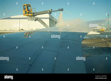 Boeing Wing Worker Is De Icing A Commercial Airliner Wing In