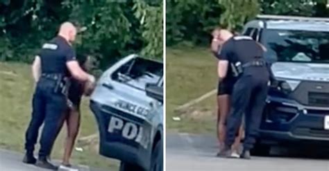 Police Launch Investigation As Cop Is Caught Kissing Woman And Joining