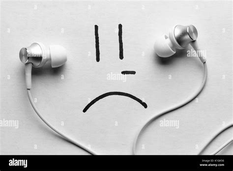 listen to sad music concept. headphones and sad smile Stock Photo - Alamy