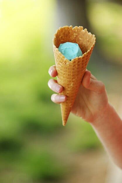 Premium Photo Midsection Of Person Holding Ice Cream