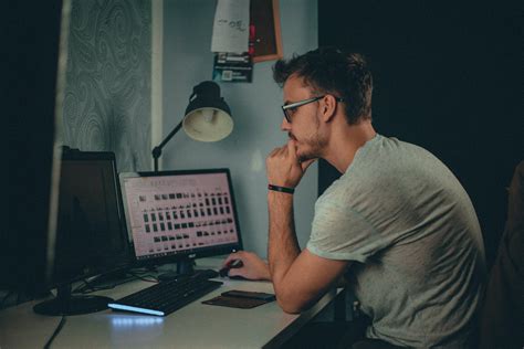 Man Using Computer Sitting On Chair · Free Stock Photo