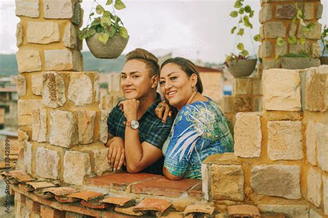 Madre E Hijo Gay Mirando Y Sonriendo Abrazados En La Terraza De Su Hogar Stock Photo Adobe Stock
