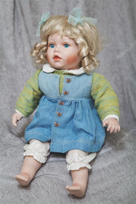 Vintage Porcelain Doll Blonde On Gray Fabric Background Stock Photo Glebchik