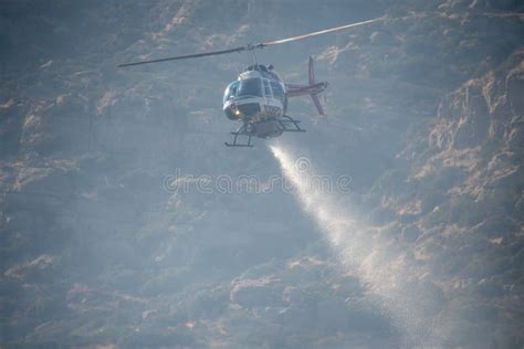 A Lafd Bell 206 Helicopter Makes A Water Drop On A Brush Fire In