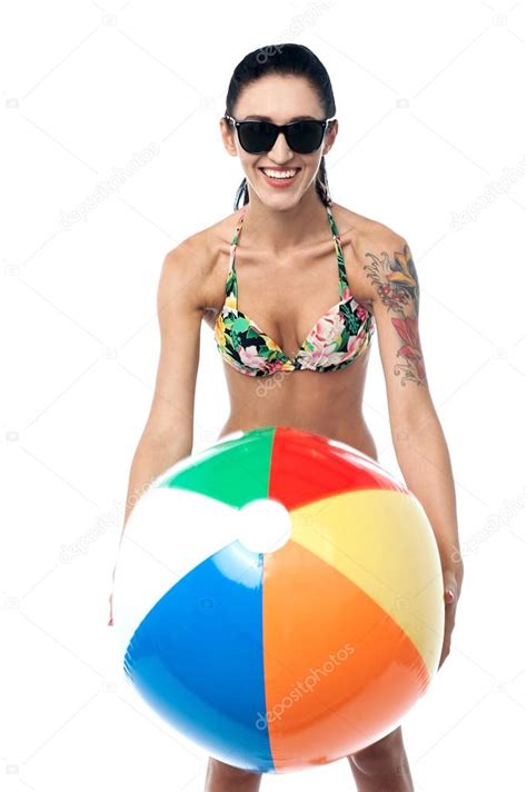 Bikini Clad Woman Playing With Beach Ball Stock Photo By Stockyimages