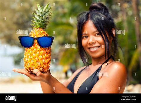 Beautiful Woman In Bikini Holding Pineapple Fruit On The Tropical Beach