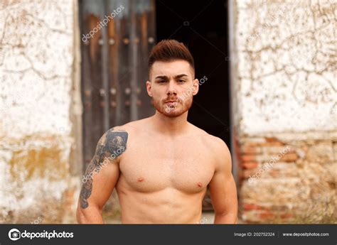 Attractive Shirtless Young Man Showing His Muscles Posing Old House