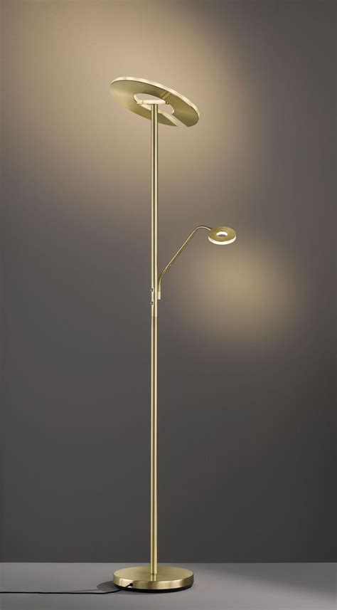 The Floor Lamp Has Two Lights On It And Is Next To A Gray Wall With A