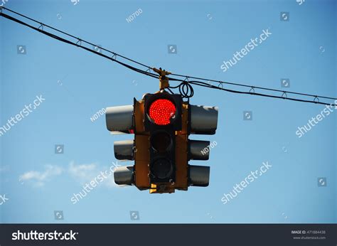 Red Traffic Light Hanging Against Sky Stock Photo (Edit Now) 471884438