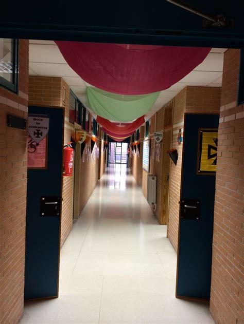 An Empty Hallway With Red And Green Banners Hanging From The Ceiling