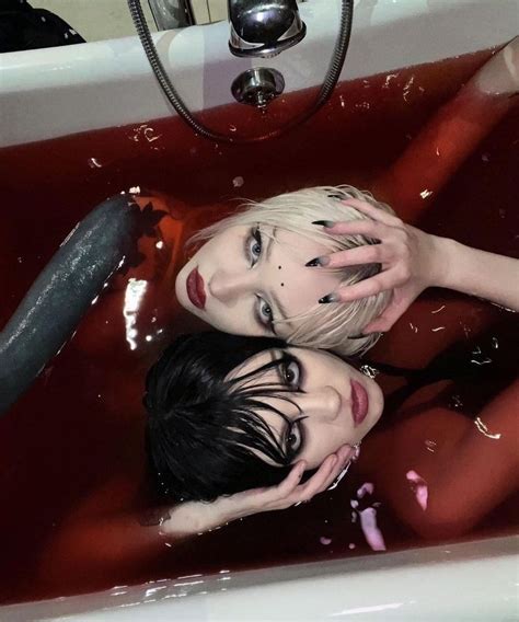 Two Girls Seated In A Bathtub Birds Eye View Blood Red Water