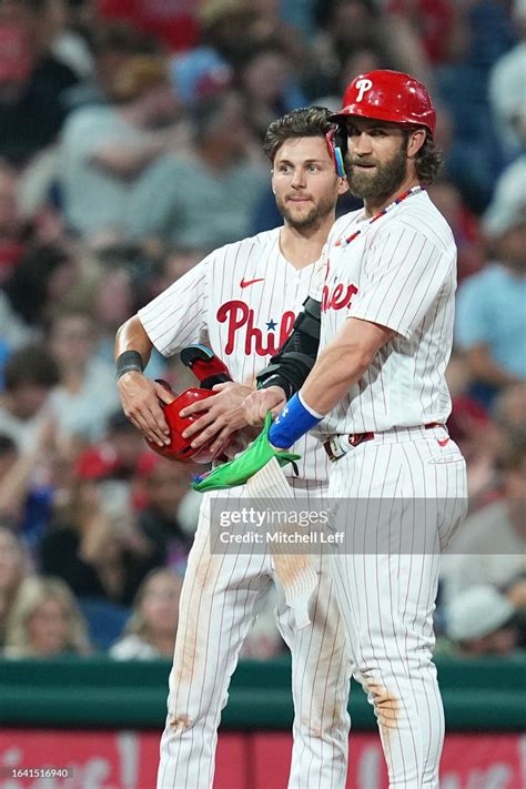 Trea Turner And Bryce Harper Of The Philadelphia Phillies Look On In