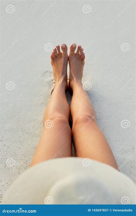 Women Beautiful Legs On The Beach Skin Care And Protection Sun Spa