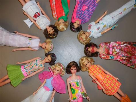 A Group Of Barbie Dolls Standing In A Circle