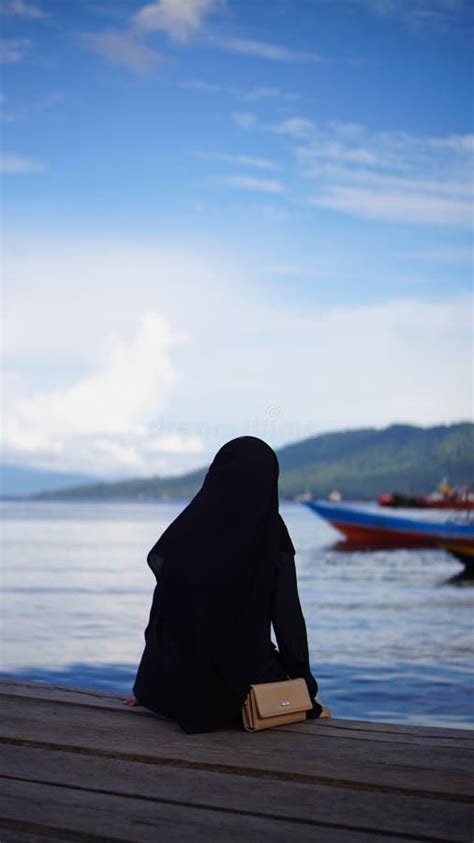 A Woman Sitting On The Edge Of The Bridge City Of Ternate Stock Image