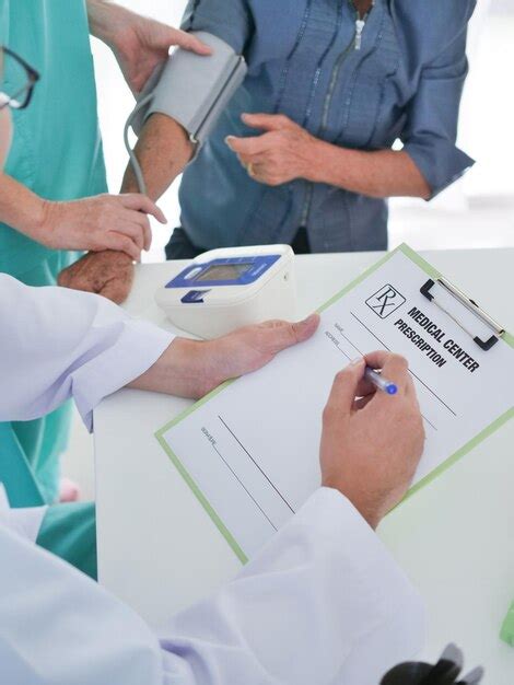 Premium Photo Midsection Of Doctor Writing On Paper While Nurse