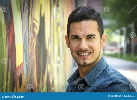 Smiling Young Man Next To Colorful Graffiti Wall Stock Image Image Of Urban Confident 40348247