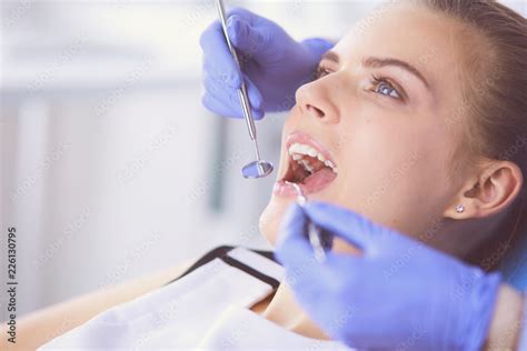 Young Female patient with open mouth examining dental inspection at ...