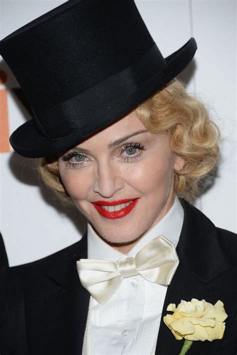 A Woman Wearing A Black Top Hat And Bow Tie With Red Lipstick On Her Lips