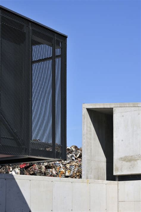 A Man Riding A Skateboard On Top Of A Pile Of Garbage Next To A Building