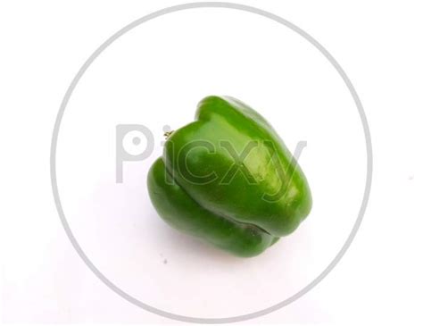 Image Of Big Green Capsicum Or Green Bell Pepper Close Up In Female