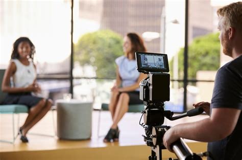 Premium Photo | Two young women on set for TV interview focus on foreground