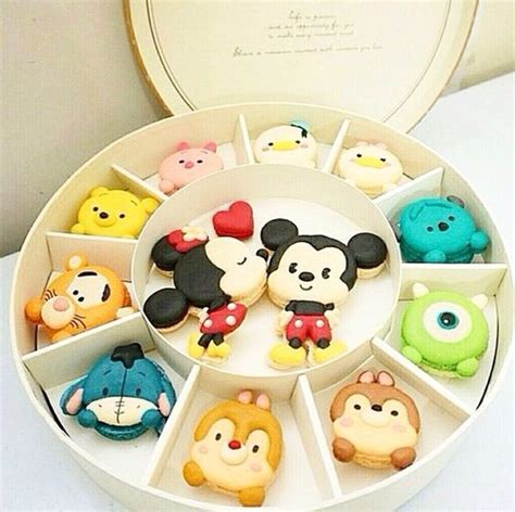 an open box filled with lots of different kinds of decorated cookies on ...