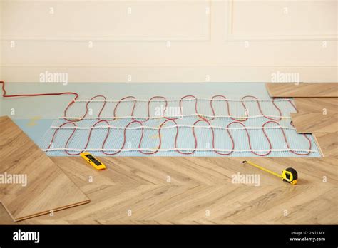 Installation Of Electric Underfloor Heating System Indoors Stock Photo