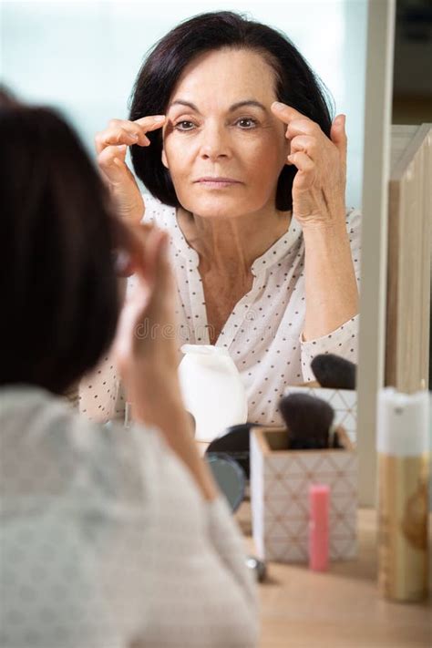 Mature Woman Makes Makeup In Bathroom Stock Photo Image Of Mirror Pleasant 265339532