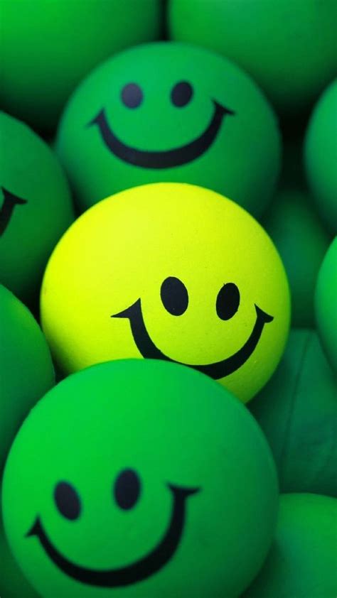 Download Yellow Smiley Ball With Green Balls Wallpaper