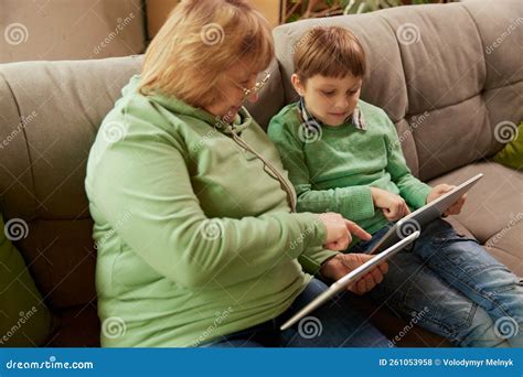 Mom Dad Granny And Grandson Together In Kitchen Preparing Food Stock