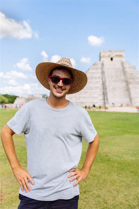 Young Smiling Tourist Man In Front Of Kukulkan Pyramid In Chichen Itza