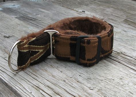 A Brown And Black Dog Collar Sitting On Top Of A Wooden Table