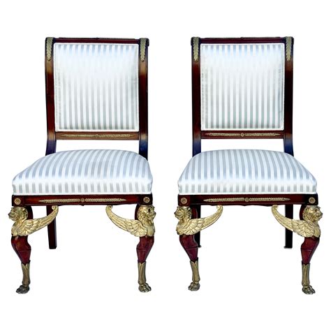 Pair Of Antique French Empire Style Mahogany And Gilt Bronze Chairs For