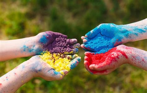 Premium Photo Hands Palms Of Young People Covered In Purple Yellow