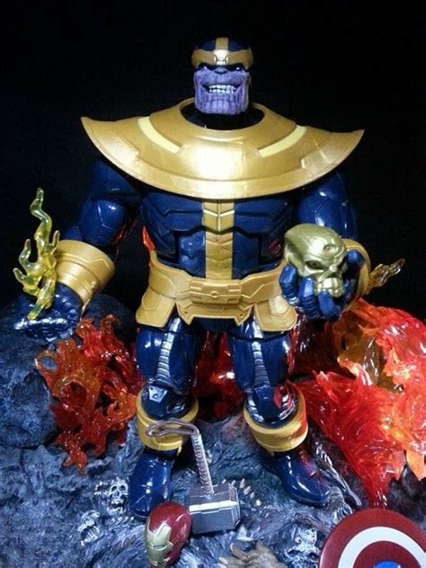 The Action Figure Is Posed On Top Of A Rock With An Iron Man Helmet