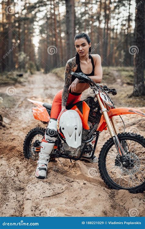 Female Racer Wearing Motocross Outfit With Semi Naked Torso Sitting On