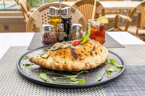 Premium Photo Authentic Italian Flavors Indulge In Our Delectable Pizza Calzone