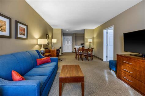 Blue couch, TV, cabinet, seating area, and desk