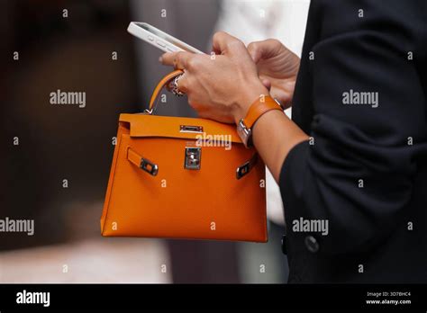 Paris France October 4 2025 Man Wears Hermes Orange Birkin Bag