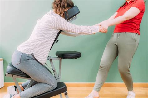 Corporate Stress Relief Chair Massage In The Office Corporate Female Employee Sitting On