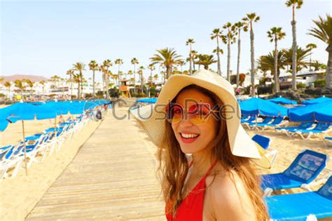 Sexy Bikini Woman Walking On Wooden Plank Between Umbrellas And Stock Photo Crushpixel