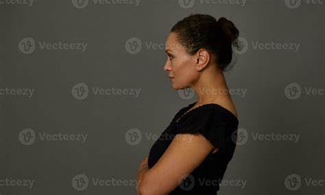 Side Portrait Of Middle Aged Woman Dressed In Black Standing Side To A