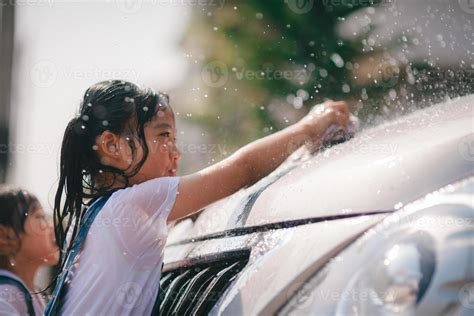 Sibling Asian Girls Wash Their Cars And Have Fun Playing Indoors On A Hot Summer Day 21698679