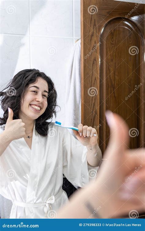 Happy Woman Brushing Her Teeth In The Bathroom Mirror Happy Girl