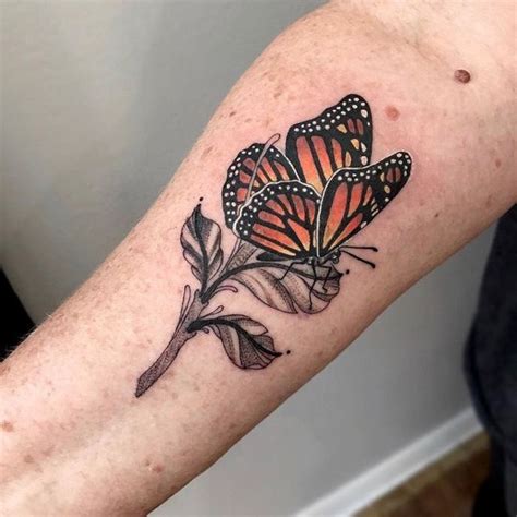 A Close Up Of A Persons Arm With Tattoos On It And Two Butterflies