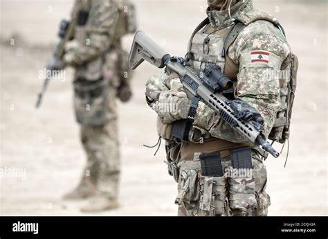 Soldiers With Assault Rifle And Flag Of Lebanon On Military Uniform