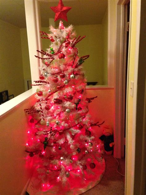 Red, Silver, and Green Decorations on a White Christmas Tree with Red ...