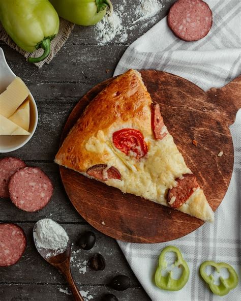 Free Photo Top View Of A Slice Of Pizza With Pepperoni Tomato Bell