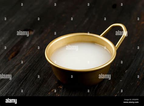 Makgeolli Korean Rice Wine on Gold Cup Stock Photo - Alamy